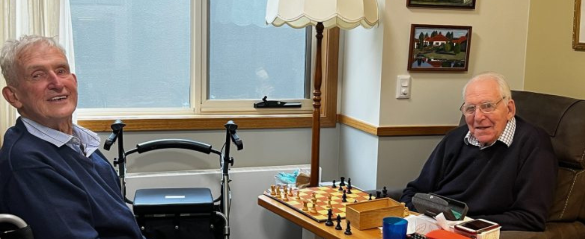 Two senior men playing chess
